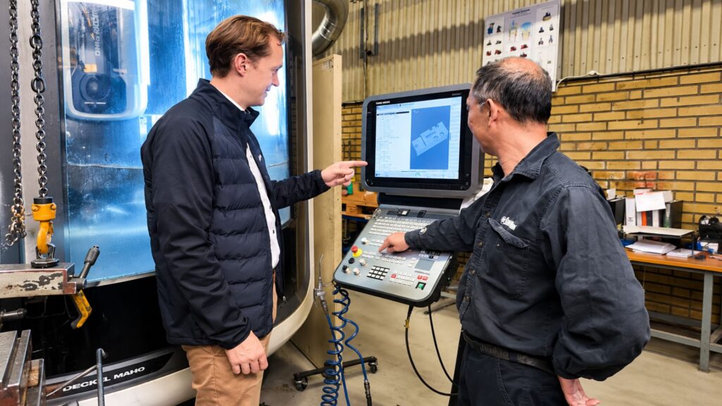Leif Abildgaard, Chris-Marine’s Chief Commercial Officer and Tan Lu Wan skilled CNC operator next to CNC machine